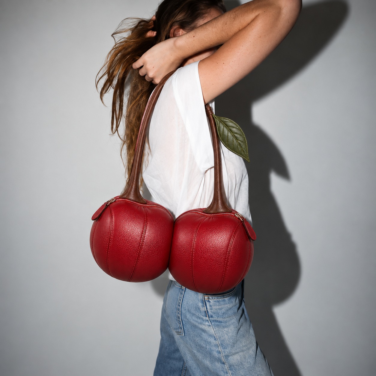 Cherry Crush with twin red cherry compartments and a continuous brown stem shoulder strap